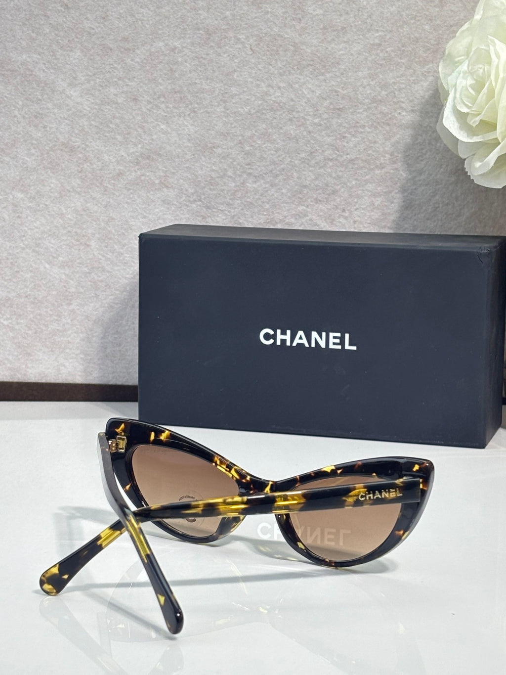Chanel cat-eye sunglasses with dark tortoiseshell frames and brown gradient lenses