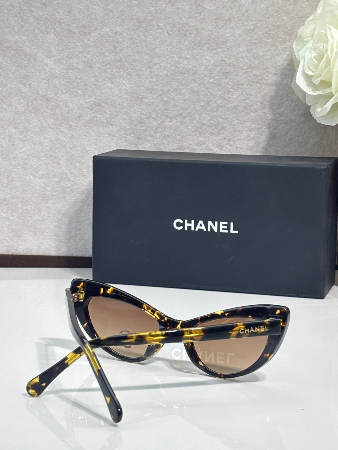 Chanel cat-eye sunglasses with dark tortoiseshell frames and brown gradient lenses