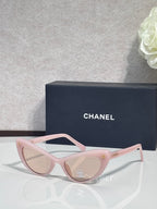 Chanel cat-eye sunglasses with light pink frames and light tinted lenses