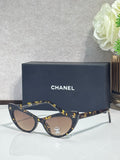 Chanel cat-eye sunglasses with dark tortoiseshell frames and brown gradient lenses