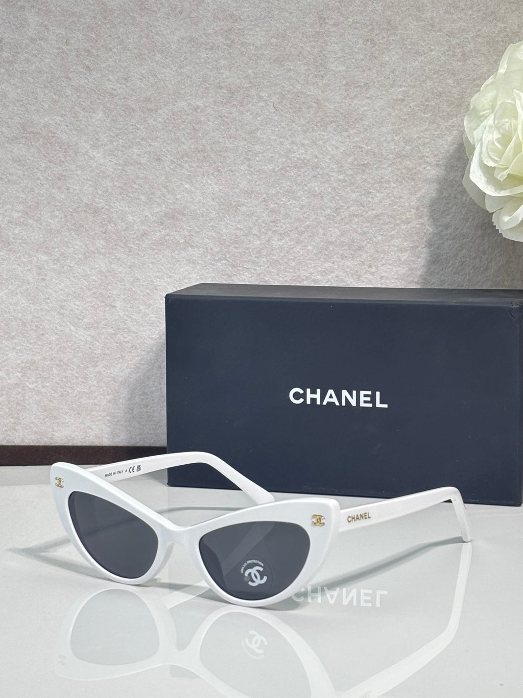 Chanel cat-eye sunglasses with white frames and dark gradient lenses