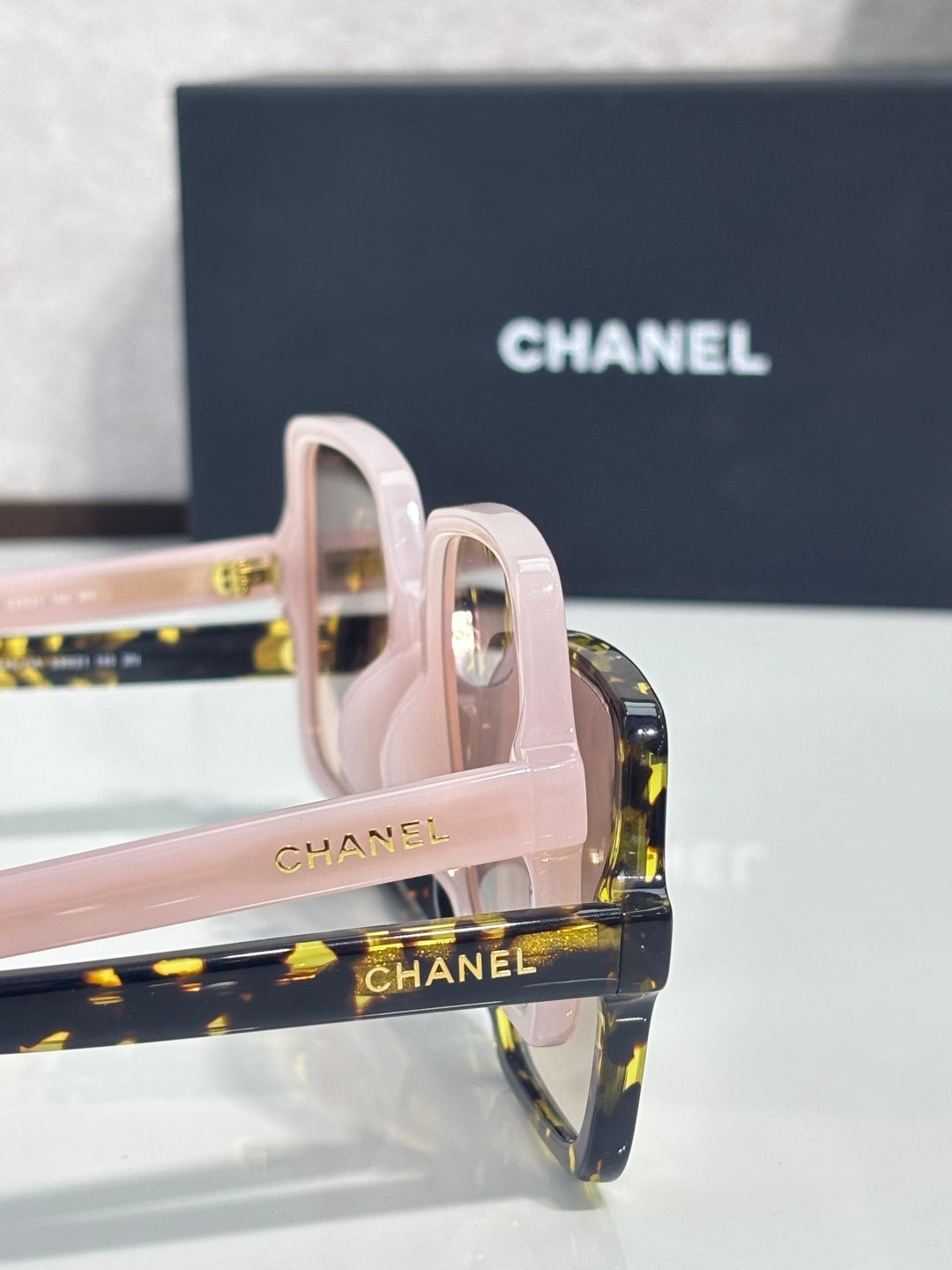 Chanel sunglasses with pink frames and dark tortoiseshell temple tips