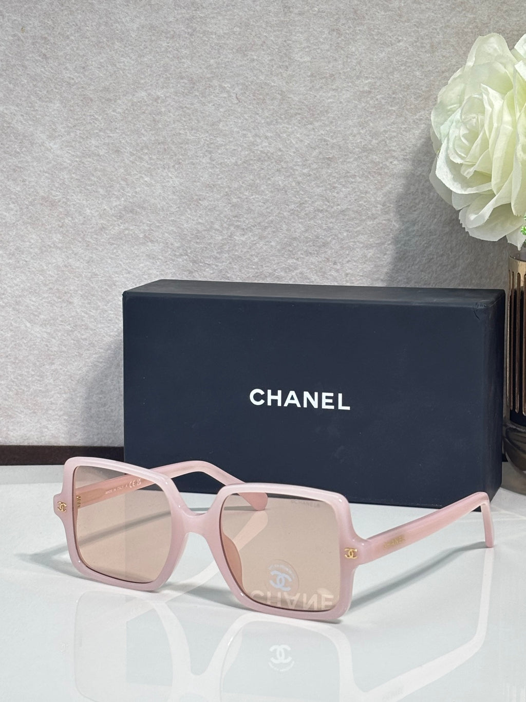 Chanel sunglasses with light pink frames and pale pink tinted lenses