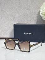 Chanel sunglasses with dark tortoiseshell frames and tan tinted lenses