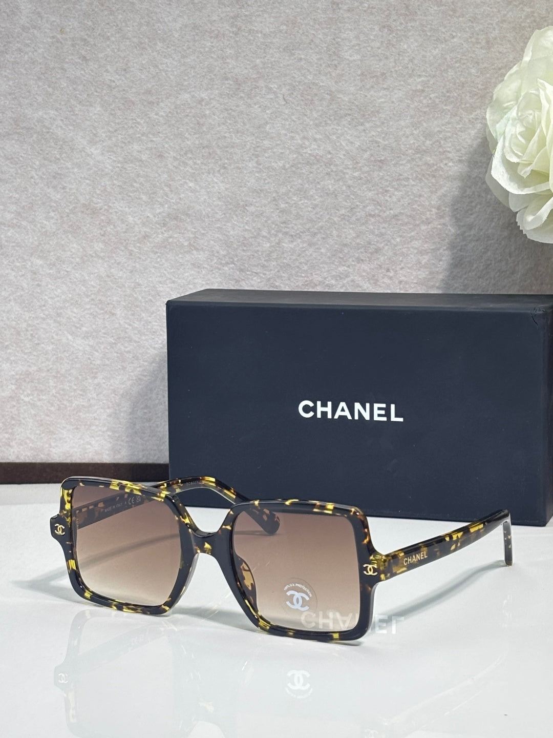 Chanel sunglasses with dark tortoiseshell frames and tan tinted lenses