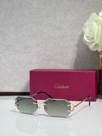 Cartier sunglasses with dark green tinted lenses and gold-tone metal frames