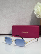 Cartier sunglasses with light blue tinted lenses and gold-tone metal frames
