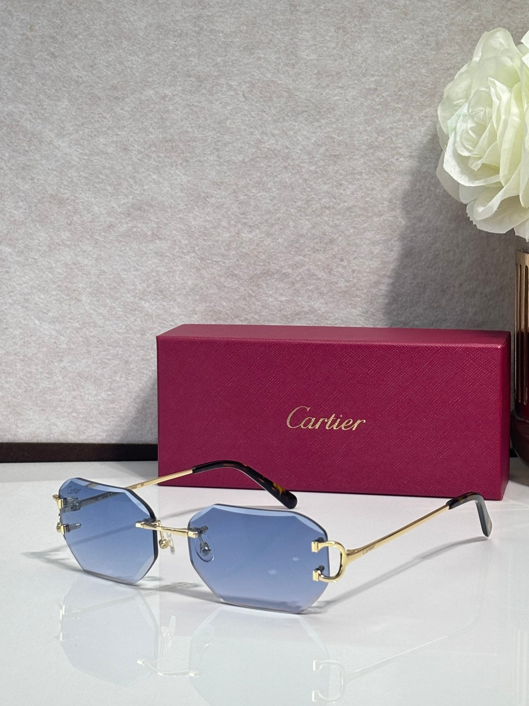 Cartier sunglasses with light blue tinted lenses and gold-tone metal frames