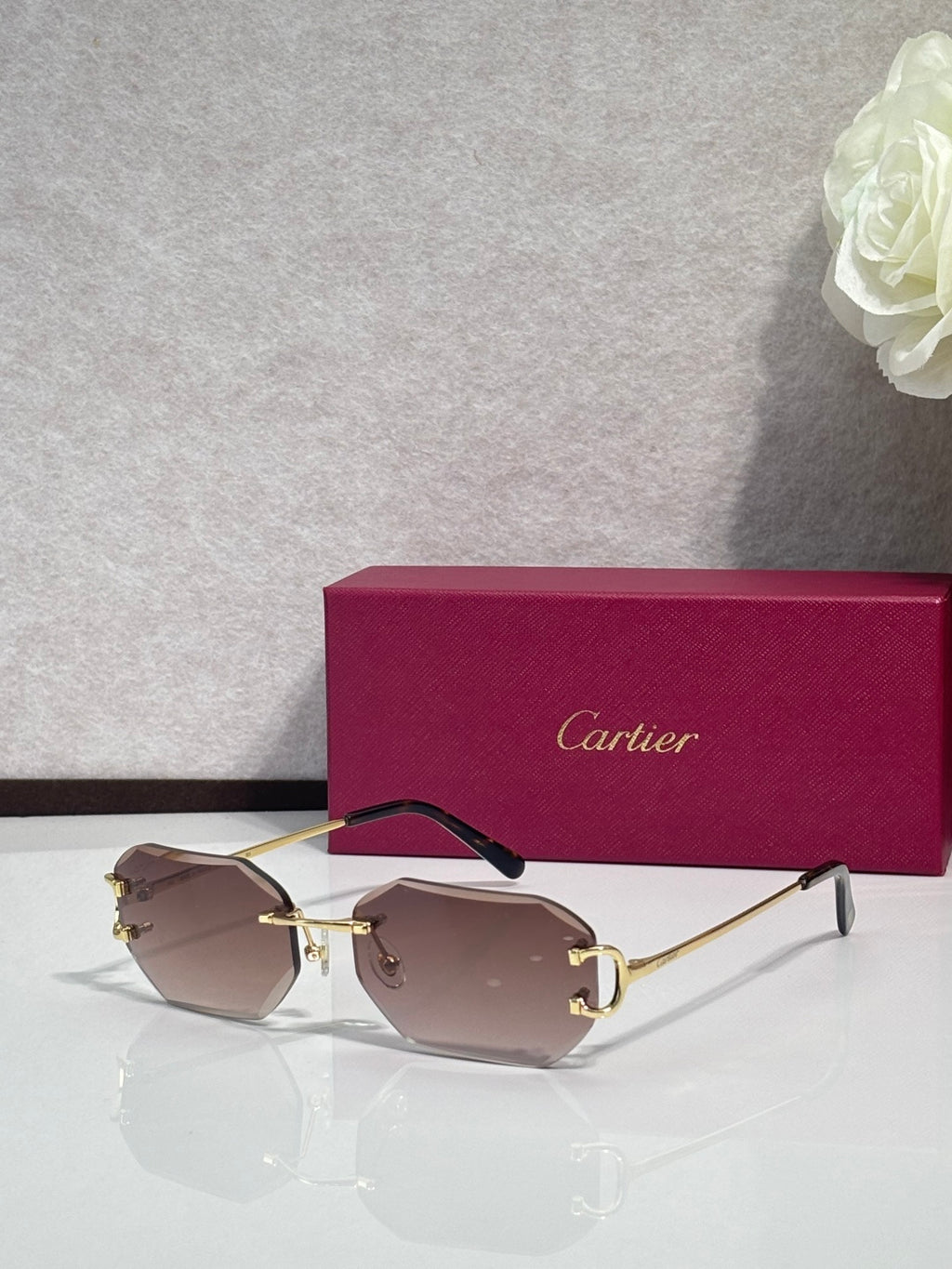 Cartier sunglasses with brown tinted lenses and gold-tone metal frames