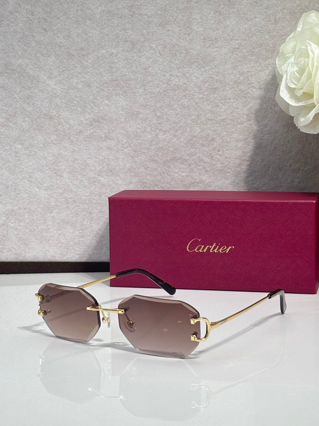 Cartier sunglasses with brown tinted lenses and gold-tone metal frames