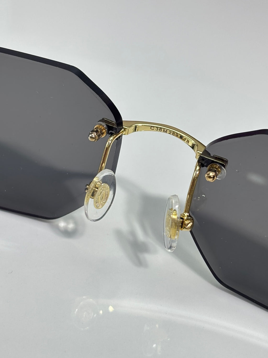 Cartier sunglasses close-up with black lenses and gold-tone frame details