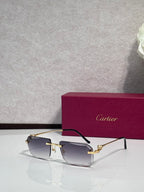 Gold-tone rectangular eyeglasses with clear-to-smoky lenses and dark temples