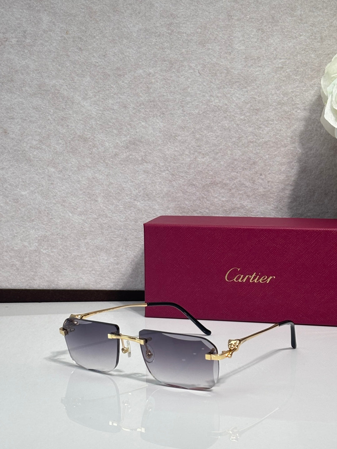 Gold-tone rectangular eyeglasses with clear-to-smoky lenses and dark temples