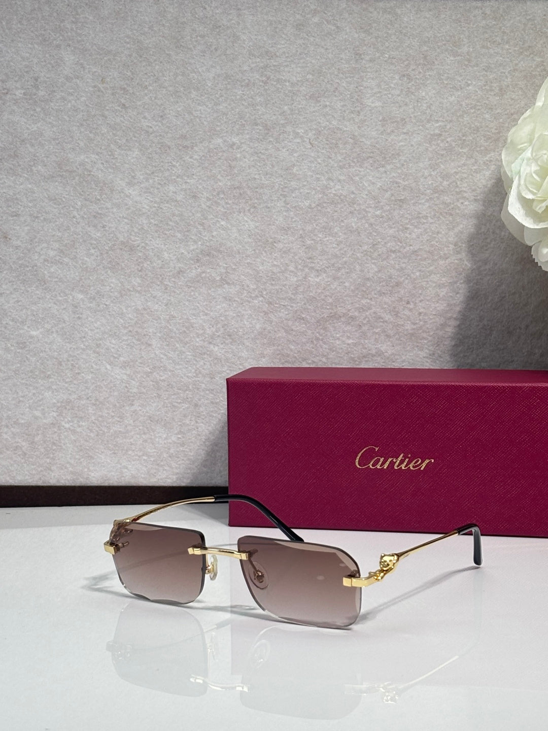 Gold-tone rectangular eyeglasses with tinted lenses and dark temples