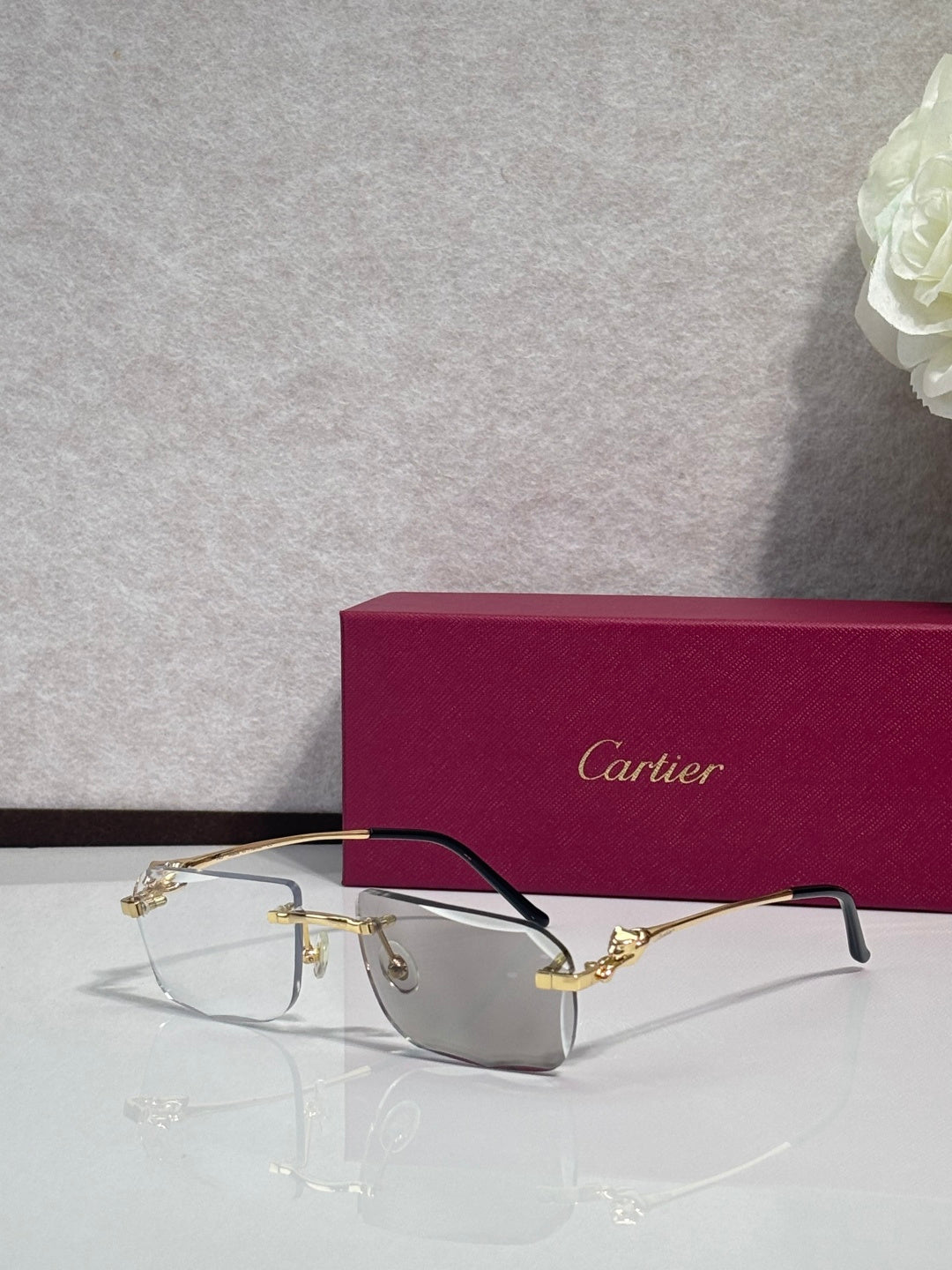 Cartier gold-tone rectangular eyeglasses with clear gray lenses and dark temples