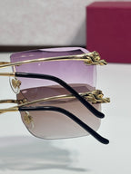 Gold-tone eyeglasses with purple-tinted lenses and curved black temple arms
