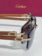 Gold-tone eyeglasses with brown lenses, wood-style temples, and detailed hinges