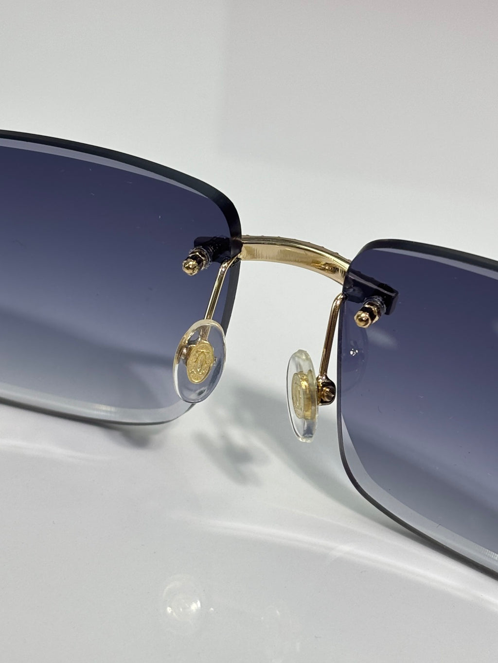 Gold-tone metal eyeglasses with blue-tinted lenses and round temple details