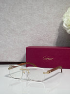 Gold-tone eyeglasses with clear front, light lenses, and wood-style temples