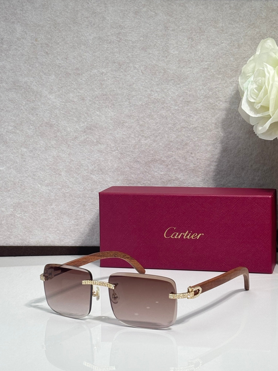 Gold-tone eyeglasses with brown lenses, clear front, and wood-style temples