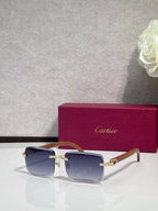 Gold-tone eyeglasses with blue lenses, clear front, and wood-style temples