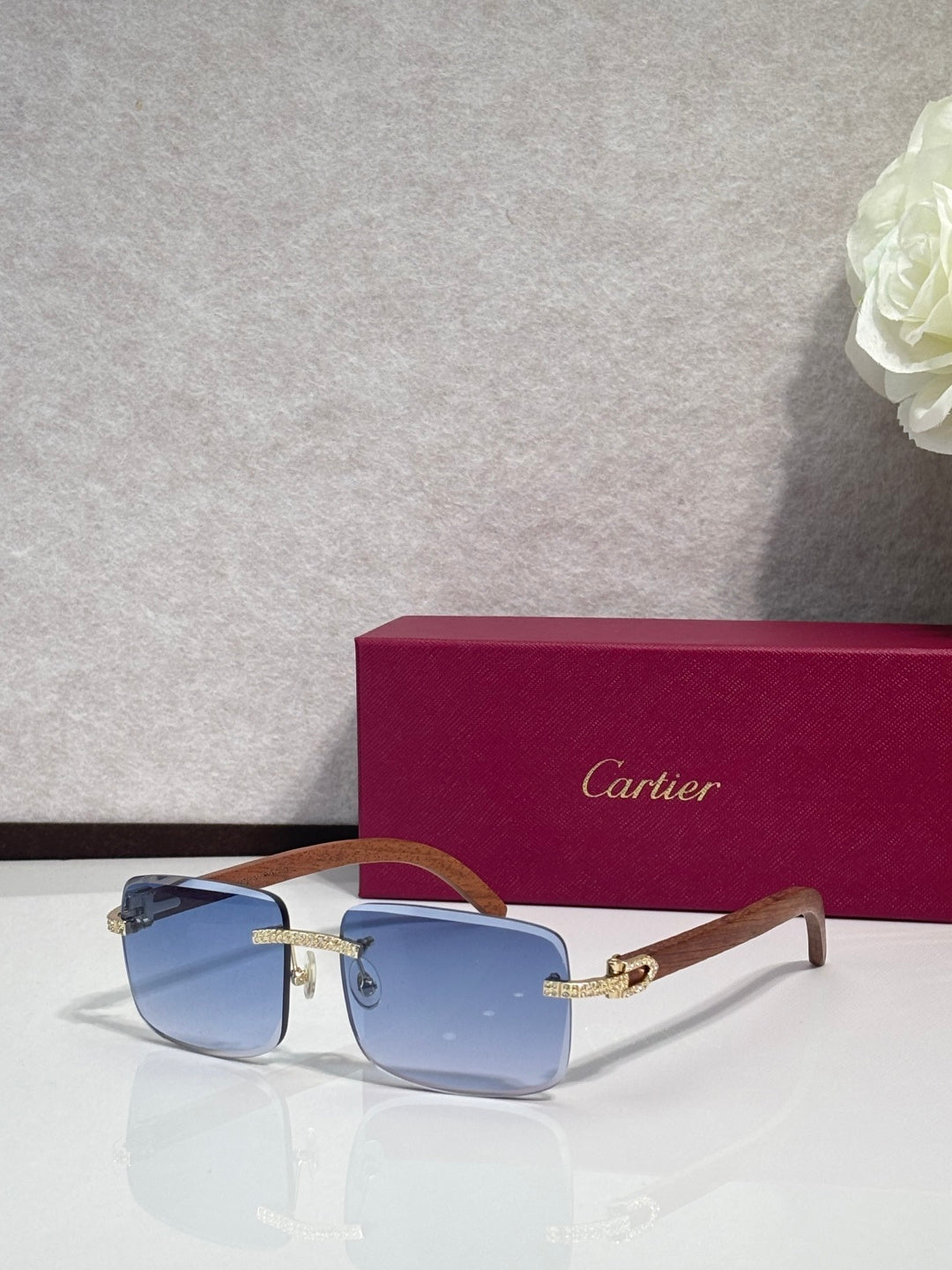 Gold-tone eyeglasses with blue lenses, clear front, and wood-style temples