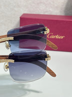 Stacked view of blue-lensed eyeglasses with gold-tone details and wood-style temples