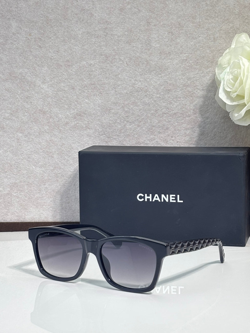 Black square sunglasses with textured temple, dark gradient lenses, low-profile logo