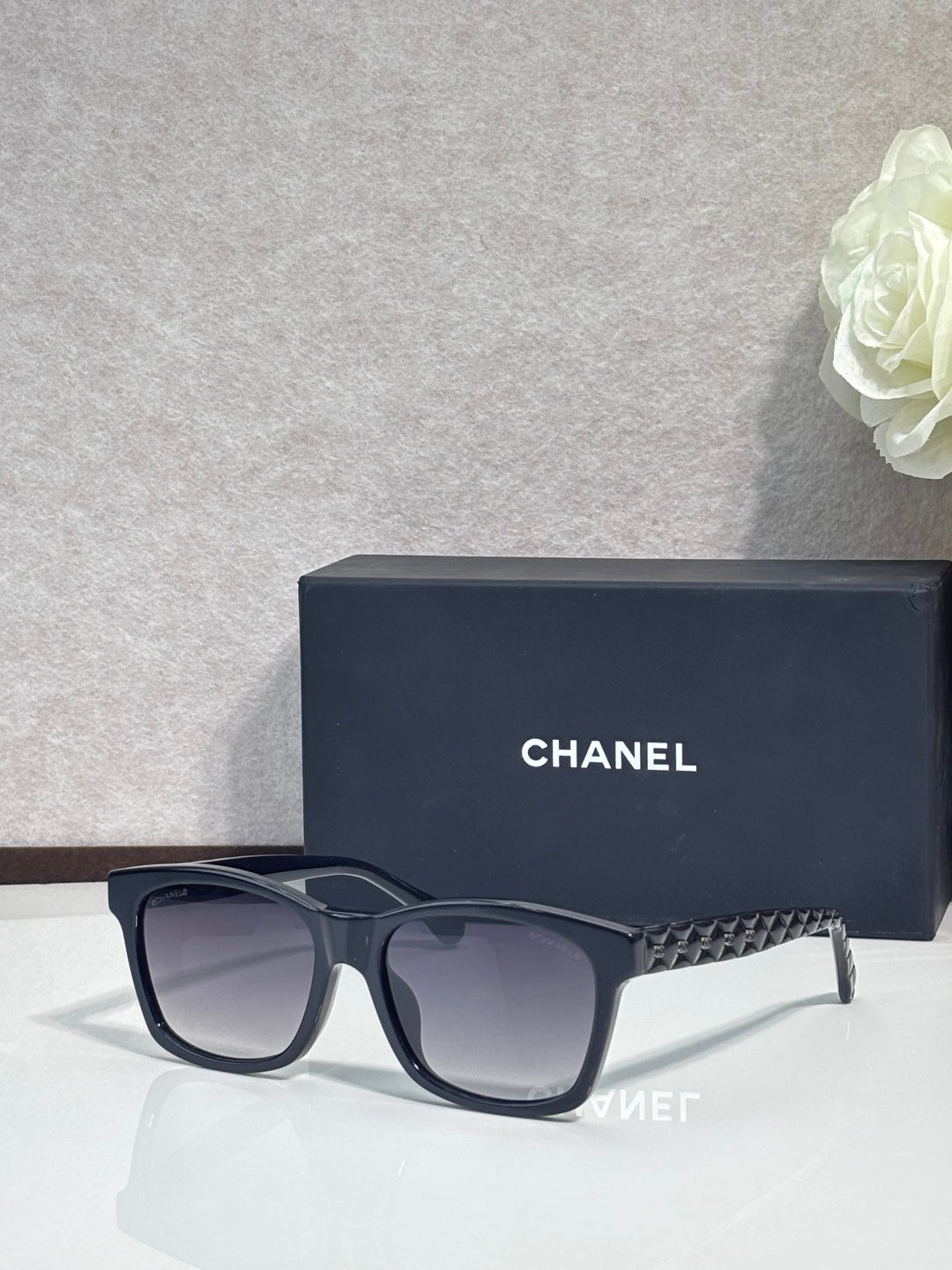 Black square sunglasses with textured temple, dark gradient lenses, low-profile logo