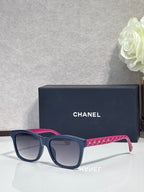 Blue square sunglasses with pink temple, dark gradient lenses, logo on frame