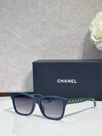 Blue square sunglasses with green patterned temple, dark gradient lenses, logo on frame