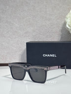 Chanel dark-lens sunglasses with black frame and silver rhinestone top trim