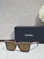 Chanel amber-lens sunglasses with dark tortoise frame and gold rhinestone detail