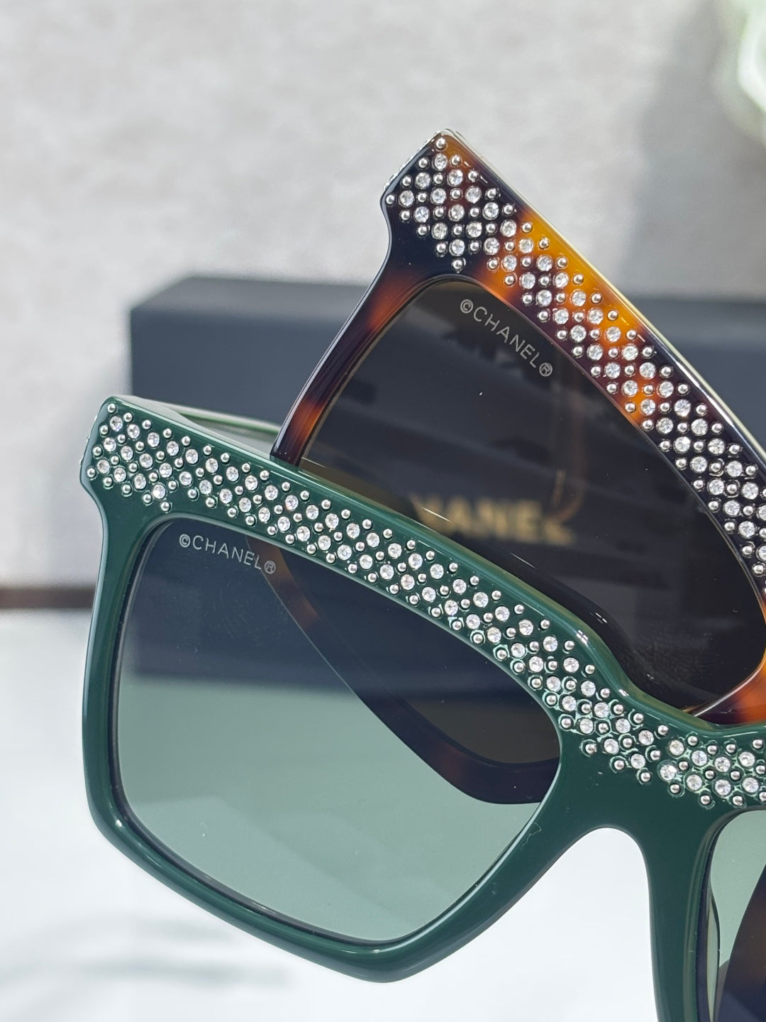Chanel green-lens sunglasses with green frame and rhinestone top panel