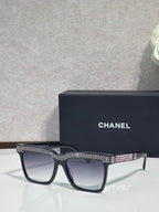 Chanel dark-lens sunglasses with black frame and silver rhinestone temple