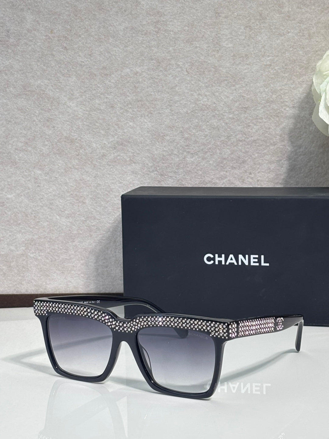 Chanel dark-lens sunglasses with black frame and silver rhinestone temple