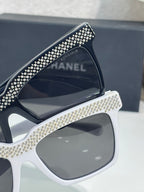 Chanel sunglasses with white frame and dark lens, edged with silver rhinestones