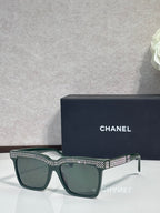 Chanel green-lens sunglasses with dark green frame and silver rhinestone top