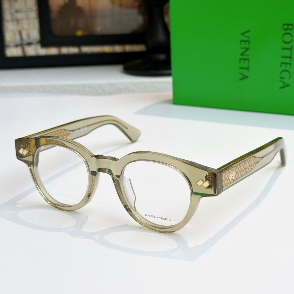 Olive-tinted acetate eyeglasses with round frames and textured gold temple panels