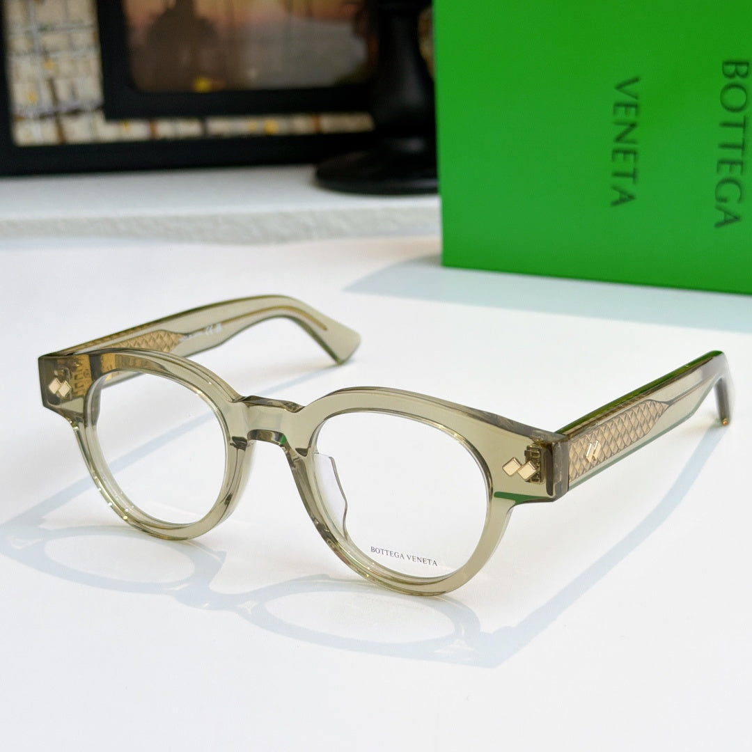 Olive-tinted acetate eyeglasses with round frames and textured gold temple panels