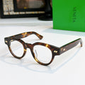 Tortoiseshell acetate eyeglasses with round frames and gold detail on temples