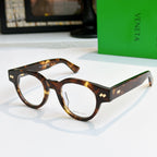 Tortoiseshell acetate eyeglasses with round frames and gold detail on temples