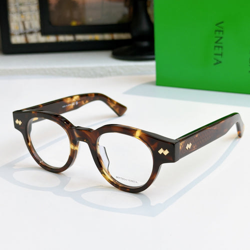 Tortoiseshell acetate eyeglasses with round frames and gold detail on temples
