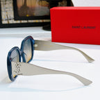 YSL sunglasses side view with blue frames, clear-gray tinted lenses, gold logo hinge detail.