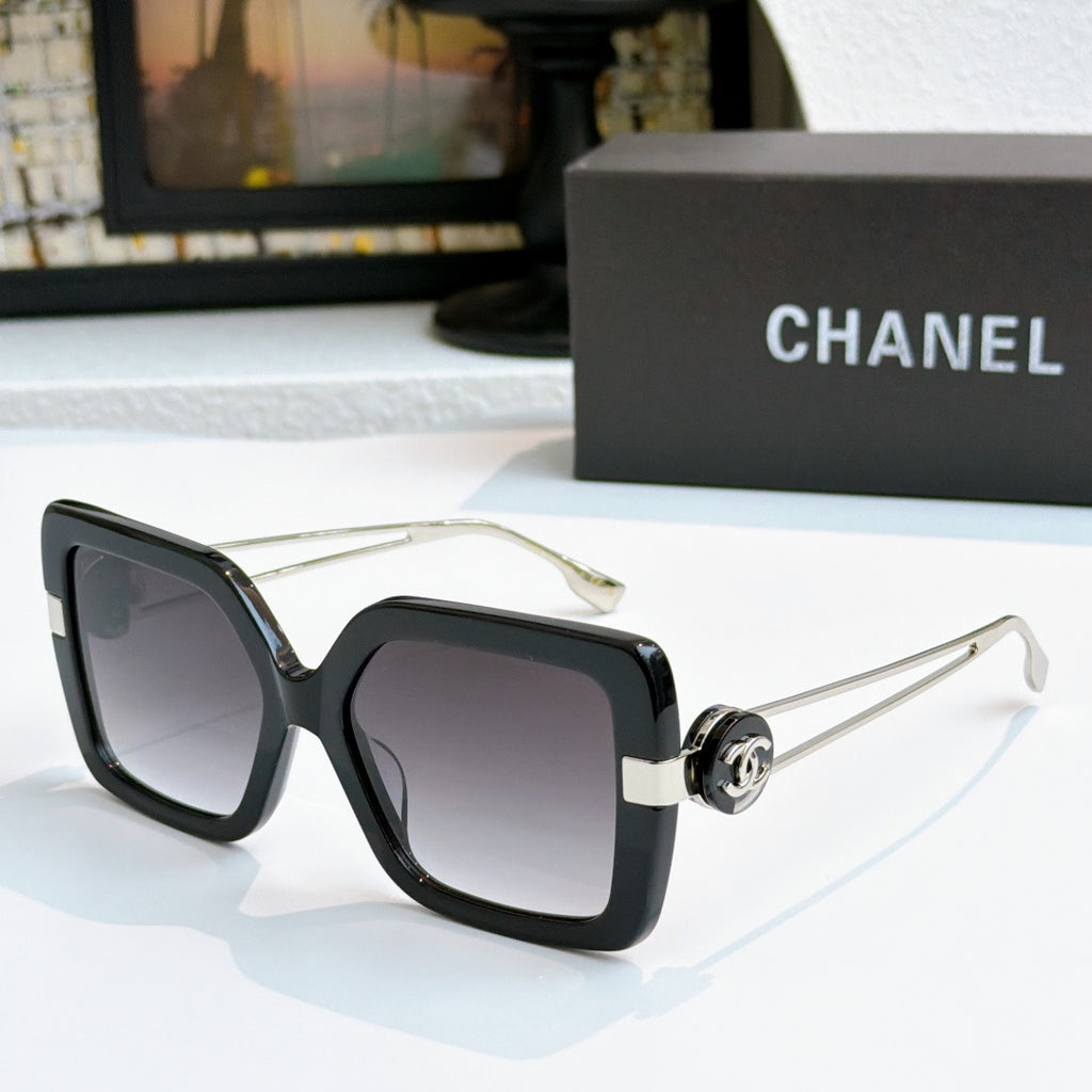 Square sunglasses with black frames and gold-tone logo arms