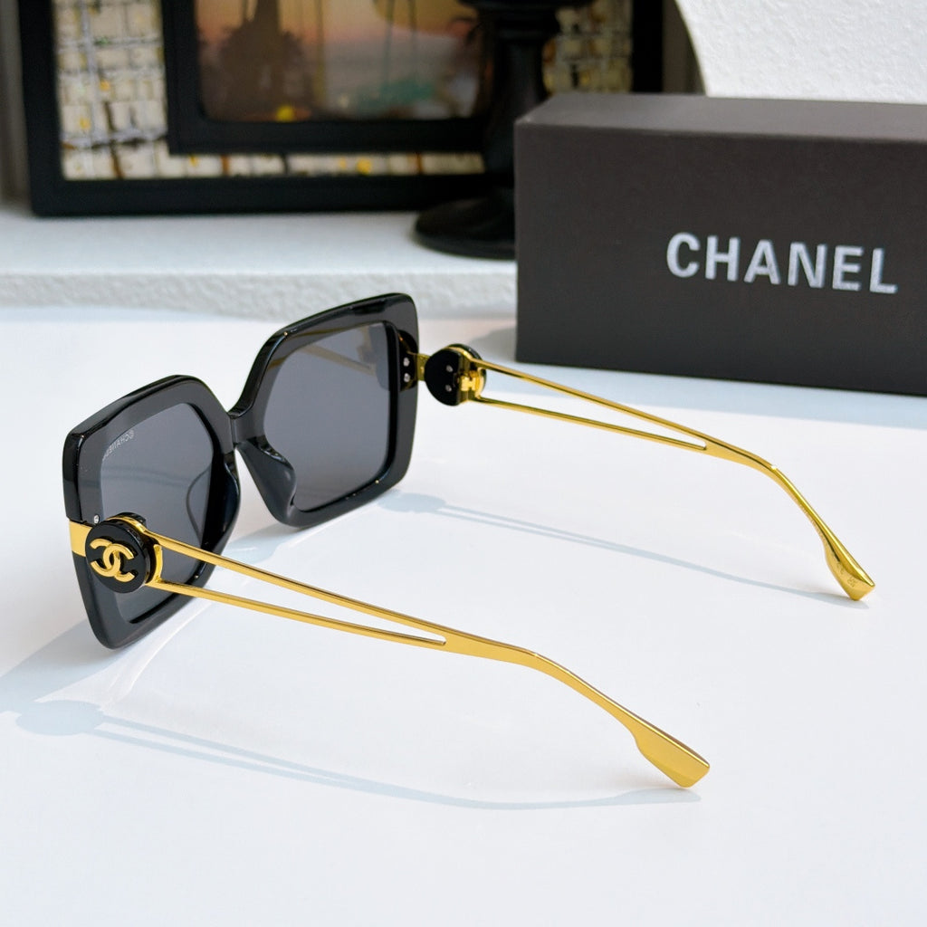 Square sunglasses with black frames and gold-tone logo arms, side view