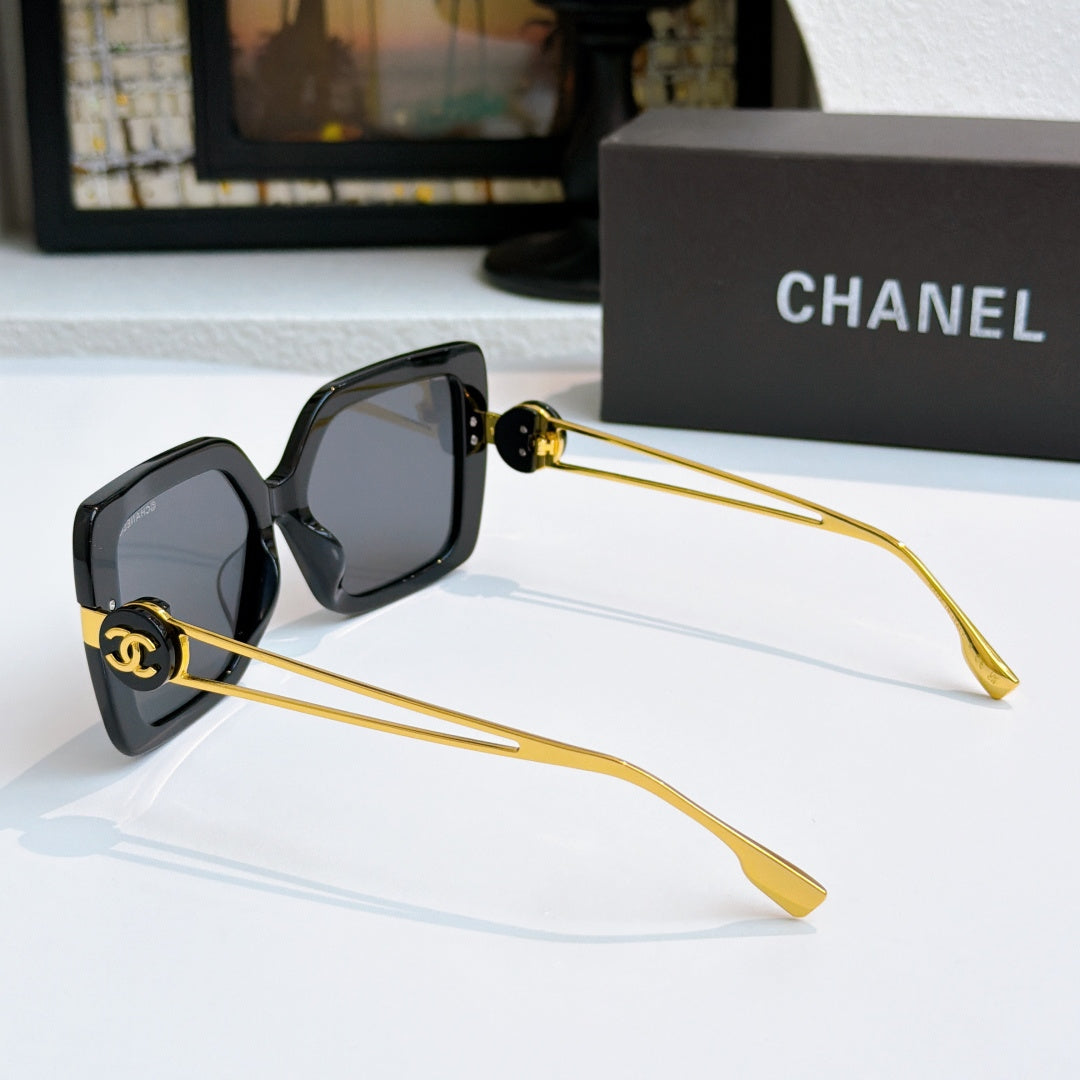Square sunglasses with black frames and gold-tone logo arms, side view