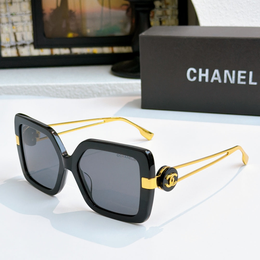 Square sunglasses with black frames and gold-tone logo arms