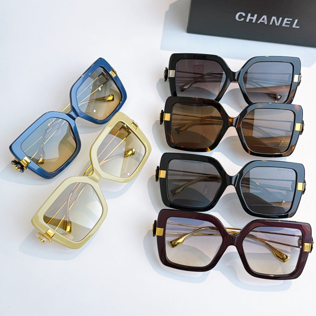 Assorted square sunglasses with colorful frames and gold-tone accents, multiple pairs
