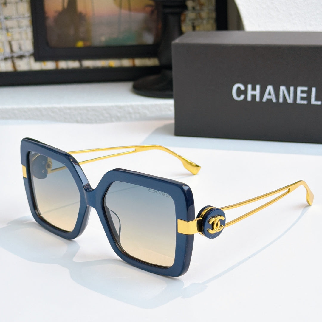 Square sunglasses with dark blue frames and gold-tone logo arms